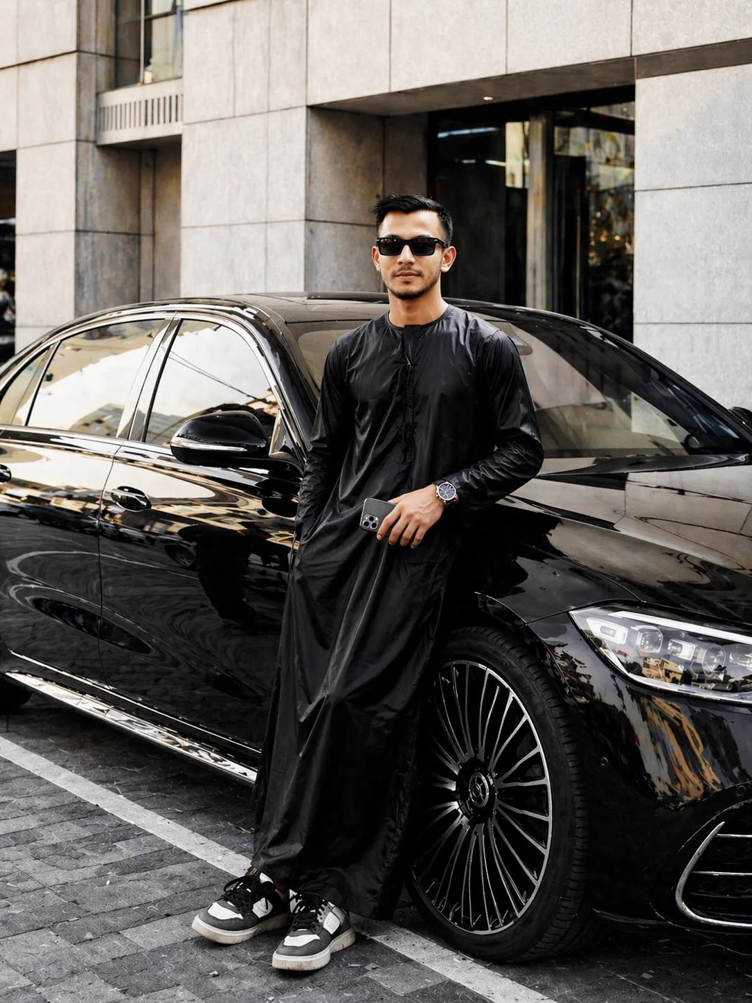Kashim Uddin Masum in a thobe beside a car